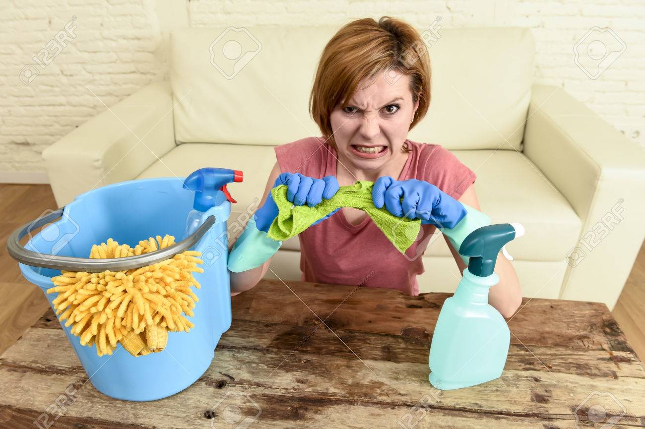 woman cleaning living room table with cloth and spray bottle tired in stress