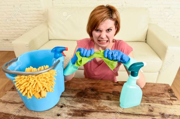 woman cleaning living room table with cloth and spray bottle tired in stress